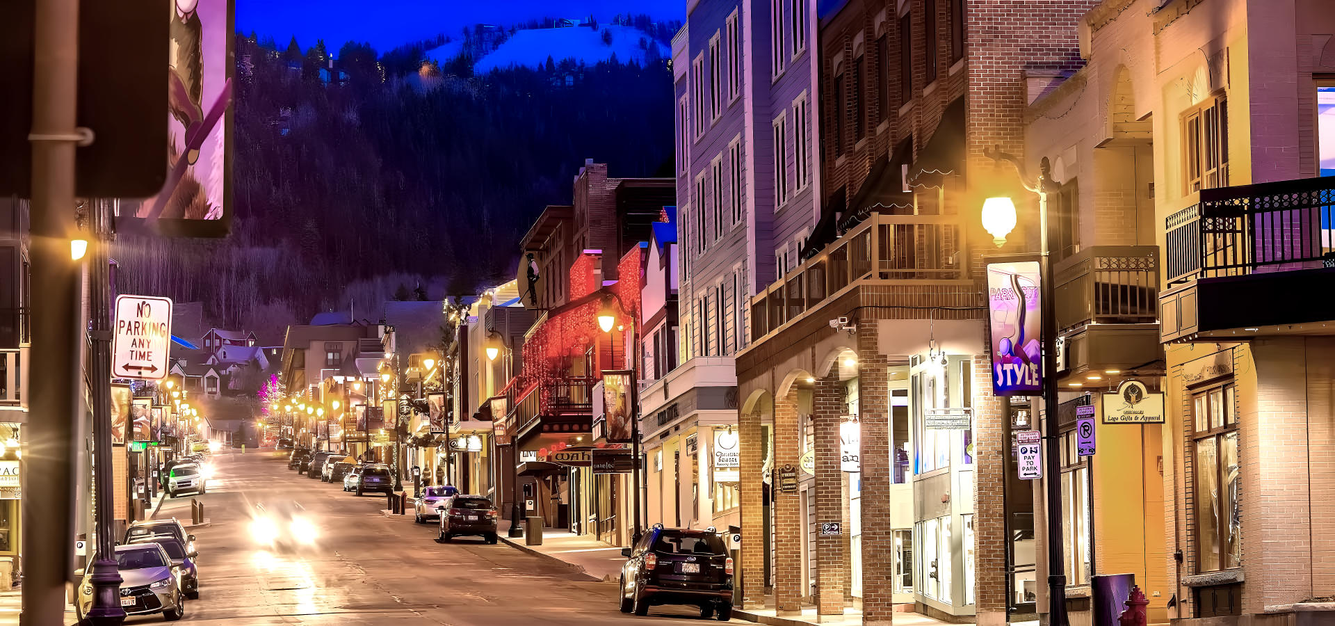 a city street with a lot of traffic with Summit Slopes luxury transportation.