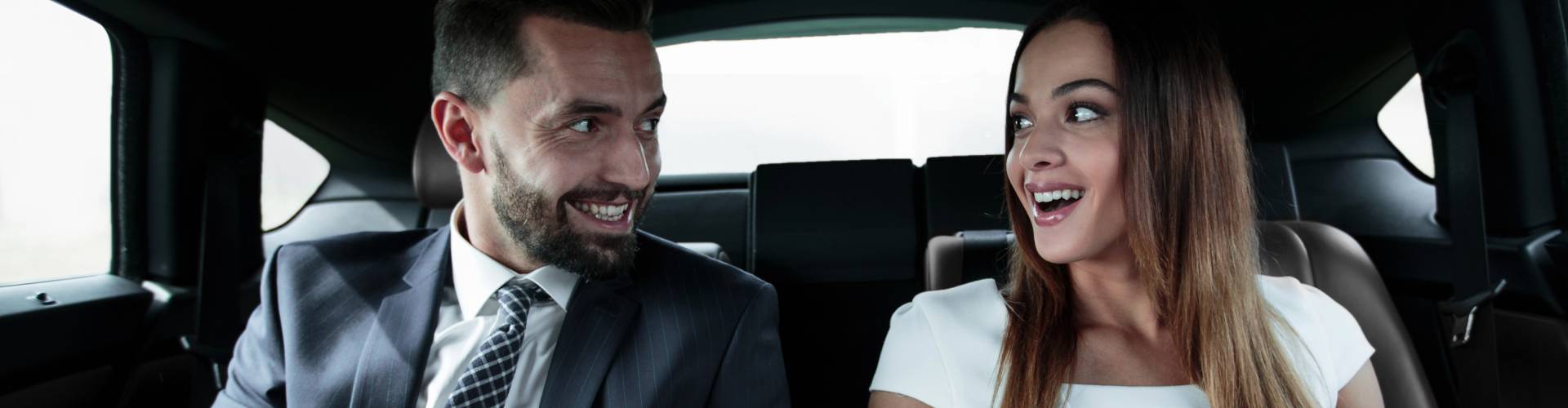 Man and woman enjoying a ride with Summit Slopes luxury transportation service.